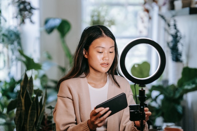 A girl recording a video for TikTok.