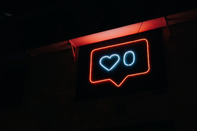 A neon sign in the shape of a heart and a zero. 