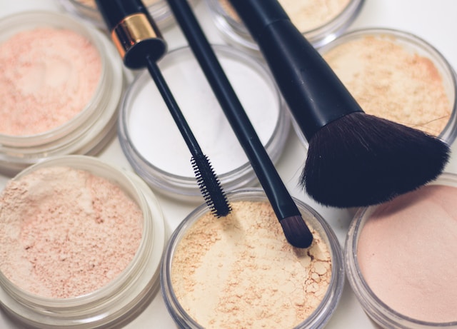 A close-up image of makeup products and brushes.