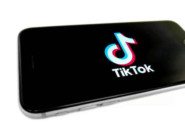 A picture of a phone displaying the TikTok logo in landscape orientation.