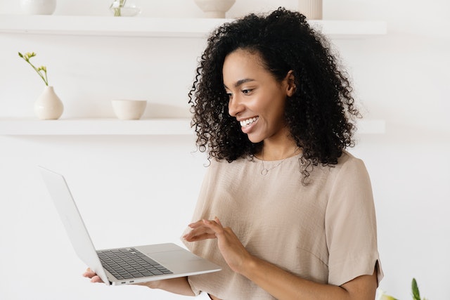 An influencer checking TikTok video downloader extensions on her laptop.