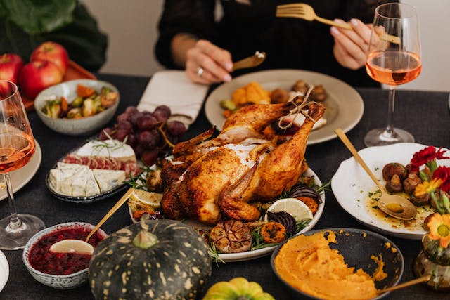 A tablescape features a wide variety of dishes for Thanksgiving. 