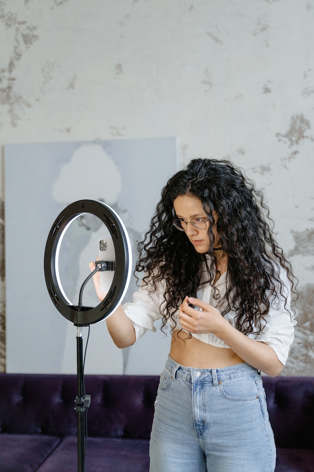 A girl setting her phone to record a TikTok vlog.