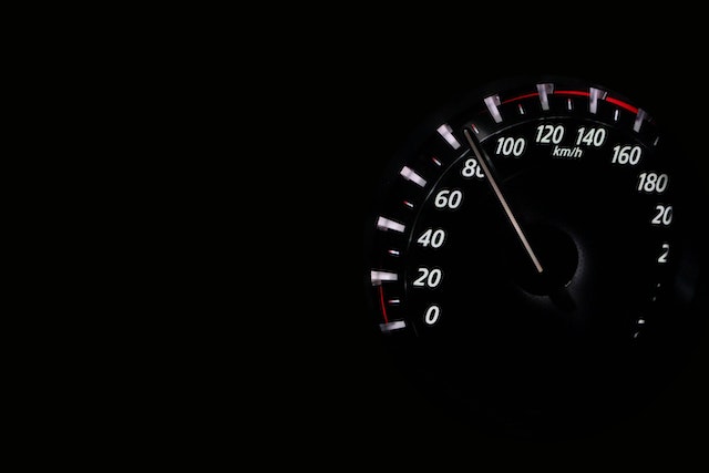 An analog speedometer shows 80 kilometers per hour speed.