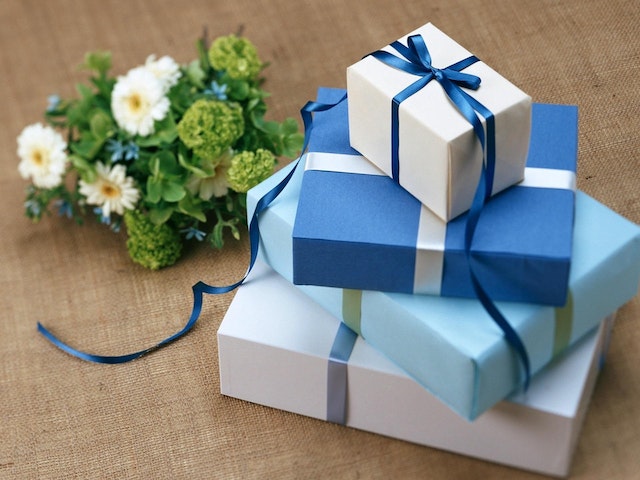 Four gift boxes sit on a table.