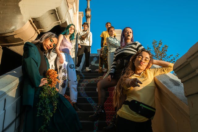 Young people stand in line on concrete steps. 
