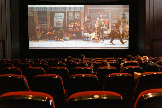 People watch a cartoon movie in a theater. 