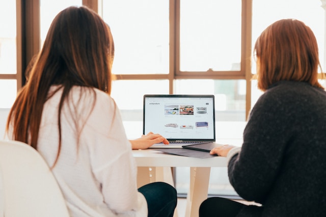 An image of two people browsing through templates on an AI content creation website.