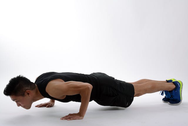 A photo of a man doing push-ups. 