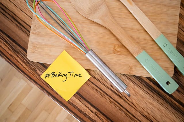 A photo of baking tools and a post-it note with the word “#BakingTime” printed on it.