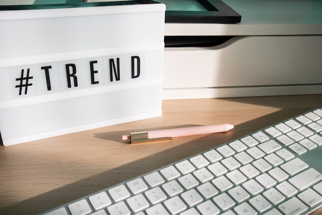 Black letter tiles spell the word “#TREND.”