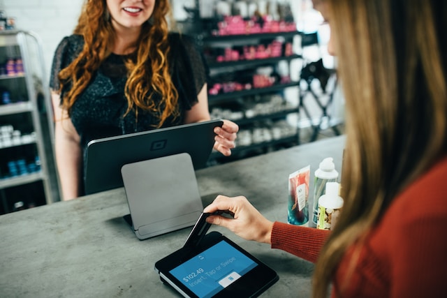 An image of a customer paying for her purchase.