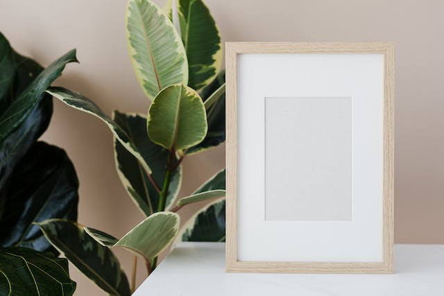 An empty picture frame sits on a table. 