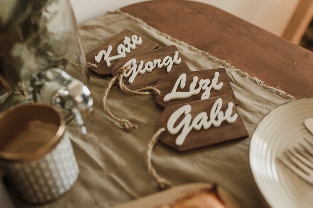 Wooden name tags sit on a table. 