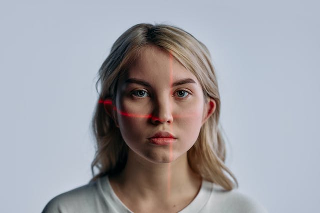 An image of a woman’s face getting scanned. 
