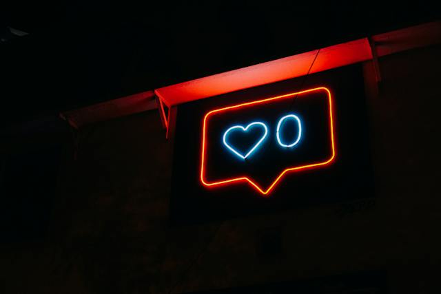 A red and blue neon sign shows a heart and zero icon.