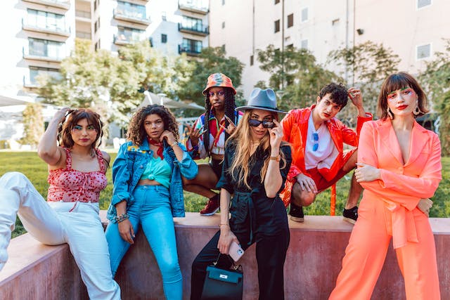 A group of women pose for a photo to model different outfits for their TikTok fans. 
