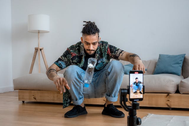 A man performs bottle tricks in front of his TikTok audience. 