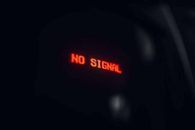 A red neon sign says, “NO SIGNAL.”