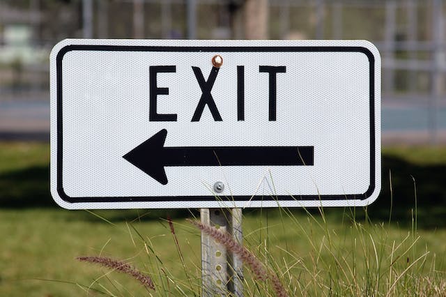 A black and white exit sign. 
