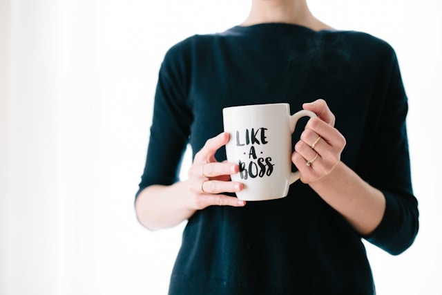 A photo of a person holding a mug printed with text that says, “Like a boss.”
