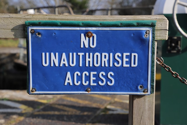 A blue and white sign says, “No unauthorized access.”

