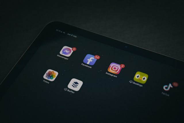 A tablet displays several social media apps, including TikTok and Instagram.

