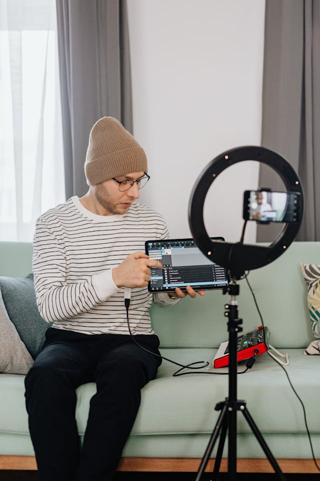 A man records an instructional video using his laptop.
