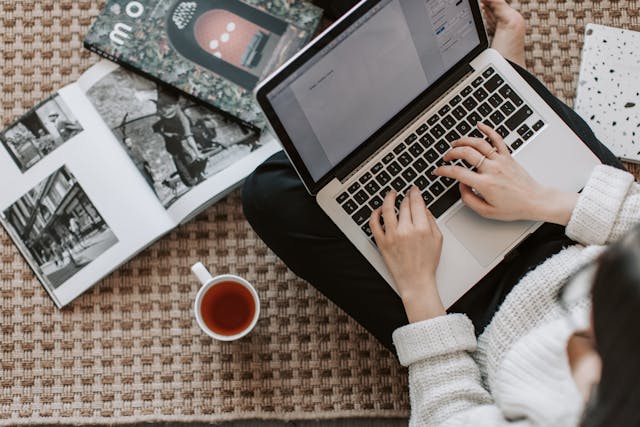 A woman types on her laptop.